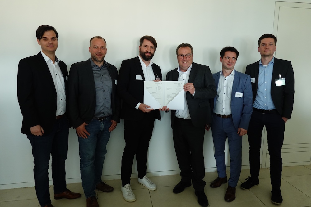 Group of people presenting a certificate