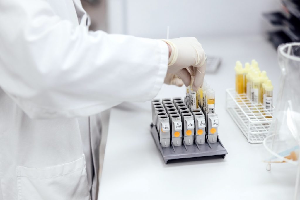A person is preparing several medical lab samples for transportation